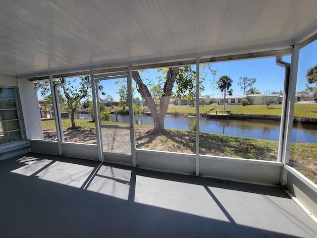 unfurnished sunroom with a water view