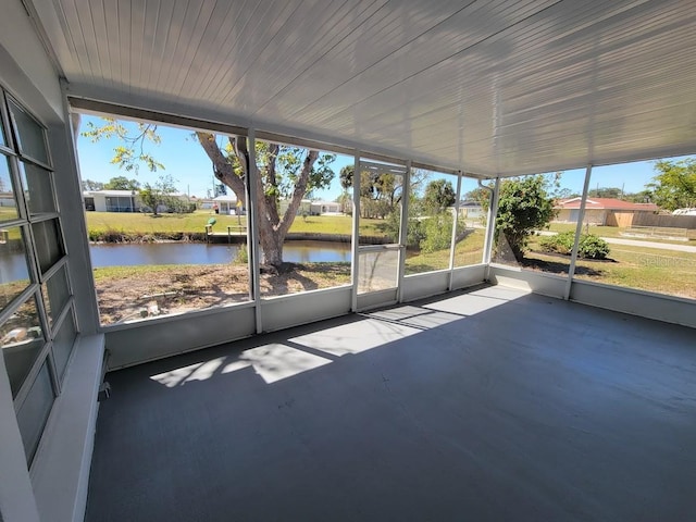 unfurnished sunroom with a water view