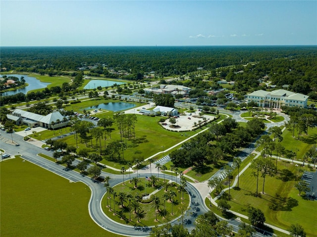 aerial view with a water view and a forest view