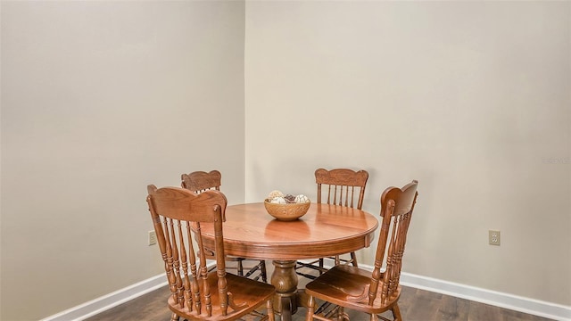 dining space with dark wood-style floors and baseboards