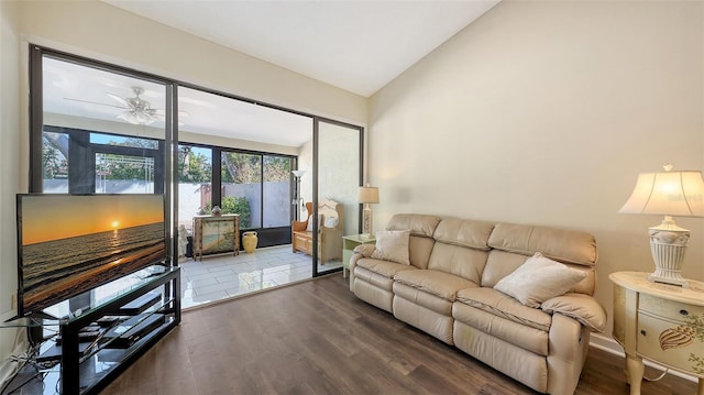 living room featuring wood finished floors, a ceiling fan, and vaulted ceiling