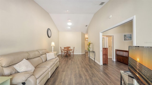 living area featuring vaulted ceiling, visible vents, baseboards, and wood finished floors