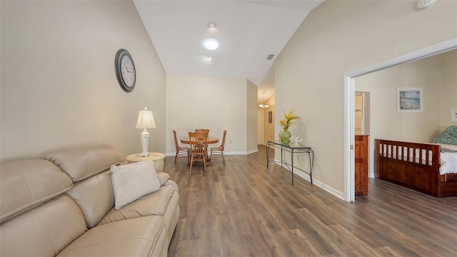 living room with baseboards, high vaulted ceiling, and wood finished floors