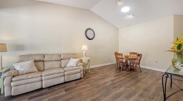 living room with wood finished floors, baseboards, and vaulted ceiling