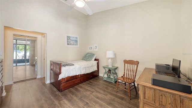 bedroom with baseboards, dark wood-style flooring, and access to outside