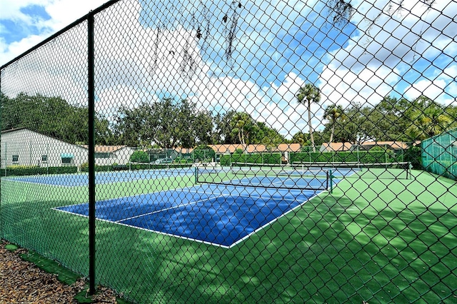 view of sport court featuring fence