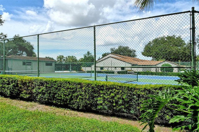 view of sport court featuring fence