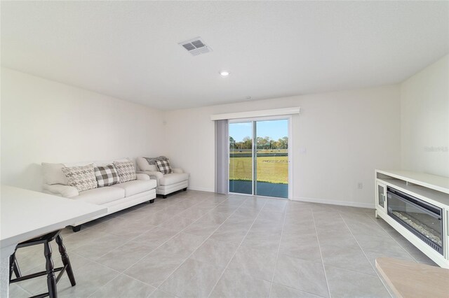 6677 SW 81st Loop, Ocala, FL 34476 - unfurnished living room featuring recessed lighting, light tile patterned floors, baseboards, and visible vents