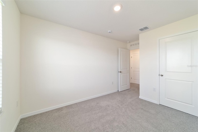 6677 SW 81st Loop, Ocala, FL 34476 - unfurnished bedroom with visible vents, baseboards, and light colored carpet