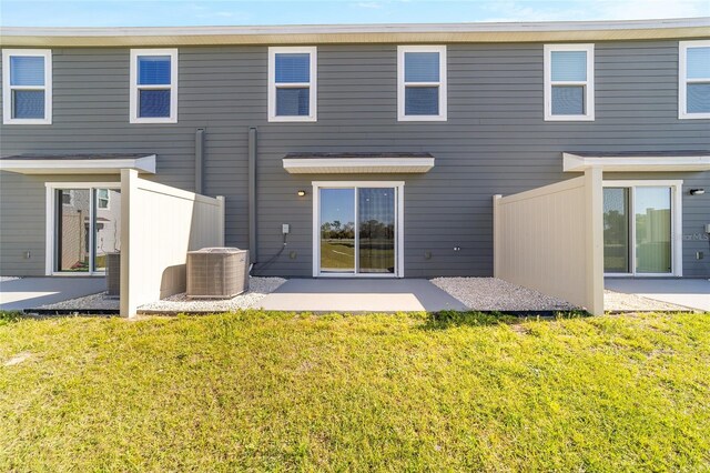 6677 SW 81st Loop, Ocala, FL 34476 - back of house featuring a yard, central AC unit, and a patio