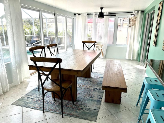 sunroom featuring a ceiling fan