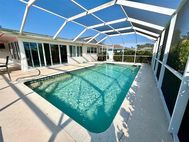 outdoor pool with a lanai and a patio