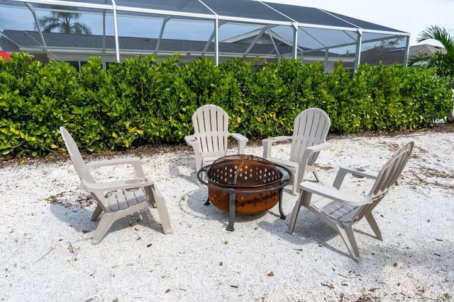 view of patio / terrace with a lanai and a fire pit