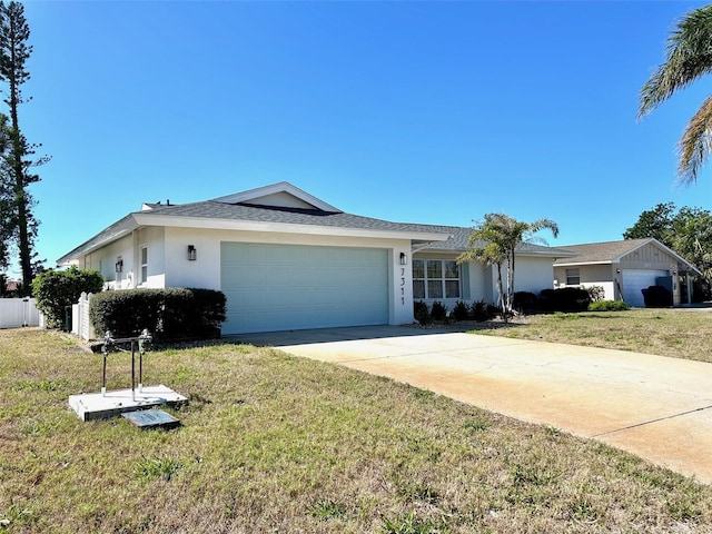 ranch-style home with a garage, a front yard, driveway, and stucco siding