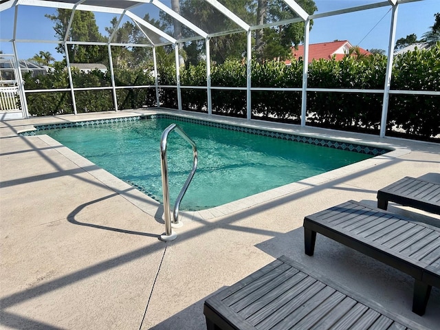 outdoor pool featuring a patio area and a lanai