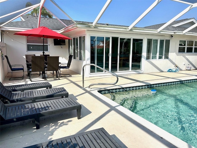 rear view of property featuring an outdoor pool, roof with shingles, a patio area, and stucco siding