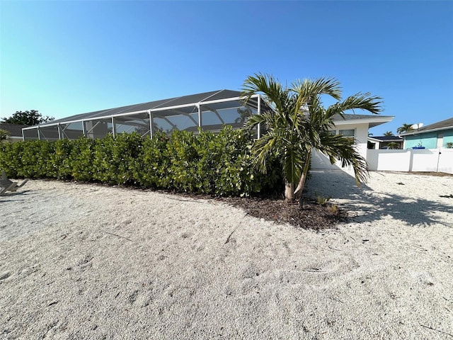 exterior space with glass enclosure and fence