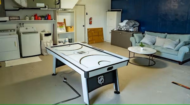 playroom with concrete flooring and separate washer and dryer