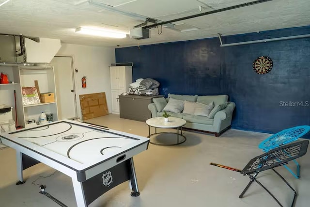 rec room featuring a garage and concrete flooring