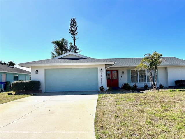 ranch-style house featuring a garage, brick siding, driveway, stucco siding, and a front lawn