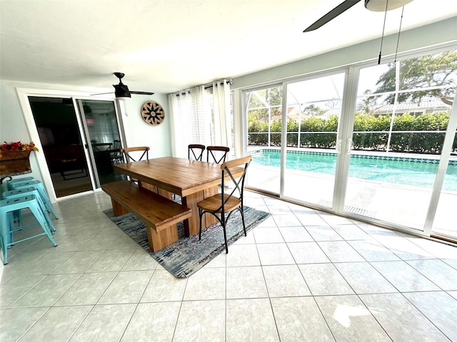 dining space with light tile patterned floors and a ceiling fan