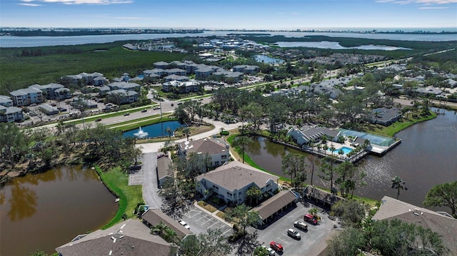 drone / aerial view with a water view and a residential view