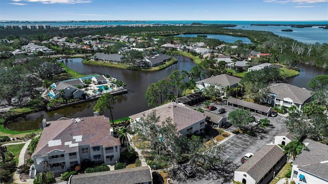 birds eye view of property featuring a water view and a residential view