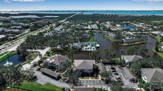 drone / aerial view featuring a residential view and a water view