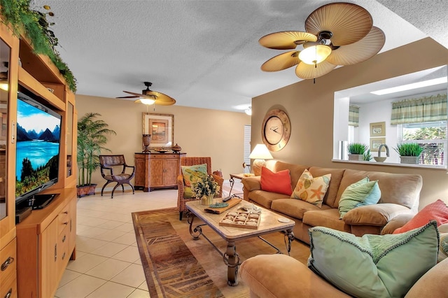 living area featuring ceiling fan, a textured ceiling, and light tile patterned floors