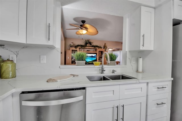 kitchen with ceiling fan, light stone counters, a sink, white cabinets, and dishwasher