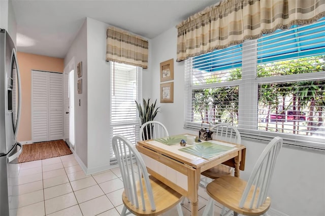 dining room featuring baseboards and light tile patterned flooring