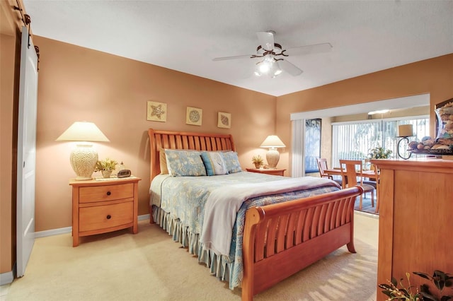 bedroom with light colored carpet, ceiling fan, and baseboards