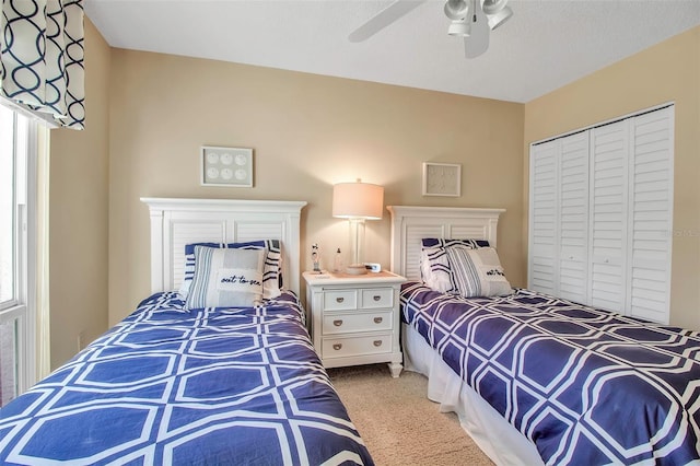 bedroom featuring carpet floors, a closet, and a ceiling fan