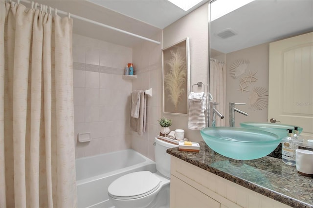 full bath with toilet, a skylight, vanity, visible vents, and shower / tub combo with curtain