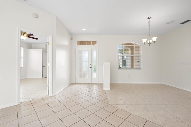 entrance foyer with baseboards, ceiling fan with notable chandelier, visible vents, and light tile patterned flooring