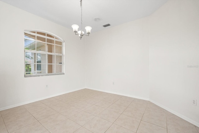 unfurnished room with a chandelier, light tile patterned floors, visible vents, and baseboards