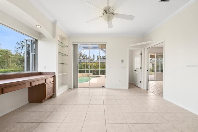 doorway with light tile patterned floors, baseboards, built in shelves, and ornamental molding