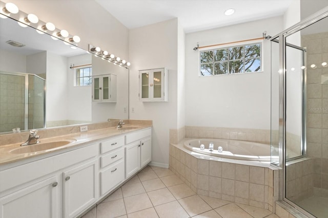 full bath featuring a stall shower, tile patterned flooring, visible vents, and a sink