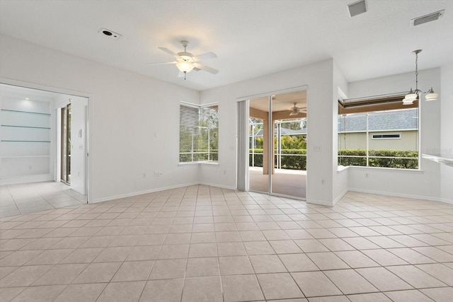 unfurnished room featuring light tile patterned floors, baseboards, visible vents, and a ceiling fan