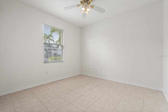 empty room featuring ceiling fan, baseboards, and light tile patterned floors