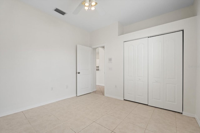 unfurnished bedroom with a closet, visible vents, baseboards, and light tile patterned flooring