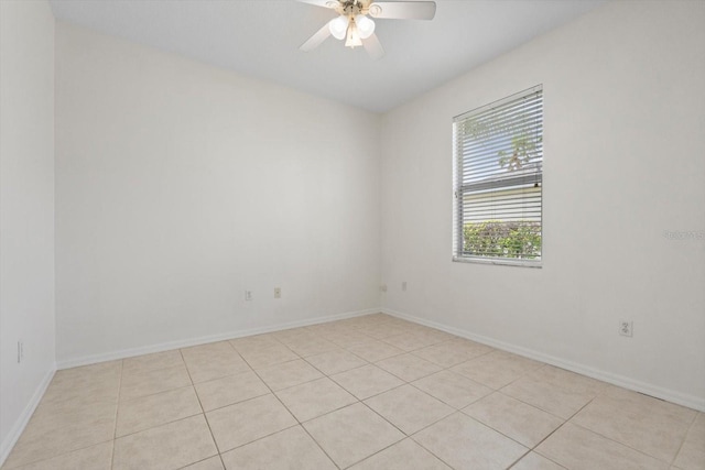 spare room with ceiling fan and baseboards