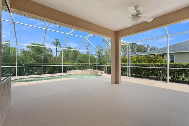 exterior space with ceiling fan, glass enclosure, and a patio area