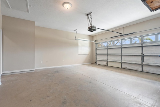 garage featuring a garage door opener and baseboards