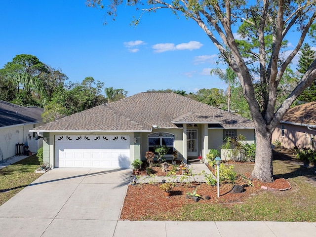 ranch-style home featuring a garage, driveway, roof with shingles, and stucco siding