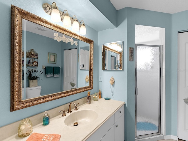 bathroom featuring a shower stall, visible vents, and vanity