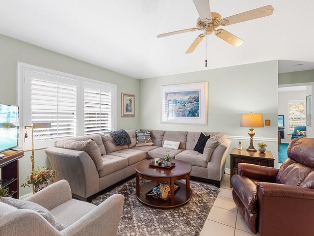 living area featuring a ceiling fan and light tile patterned flooring