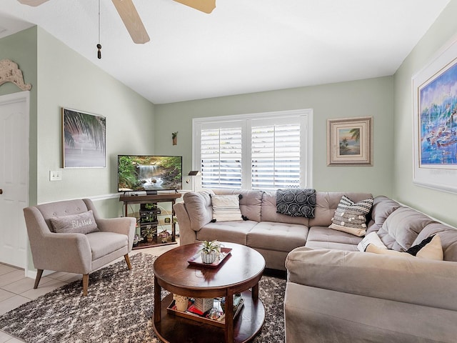 living area with lofted ceiling, ceiling fan, and light tile patterned flooring