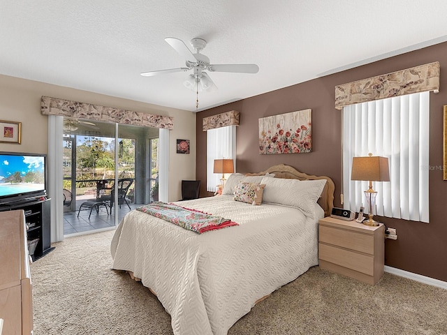 bedroom with a textured ceiling, light colored carpet, a ceiling fan, baseboards, and access to outside