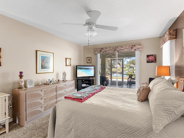 bedroom with carpet floors, access to outside, a textured ceiling, and a ceiling fan